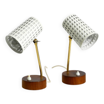 A pair of mid-century modern bedside lamps with perforated metal shades