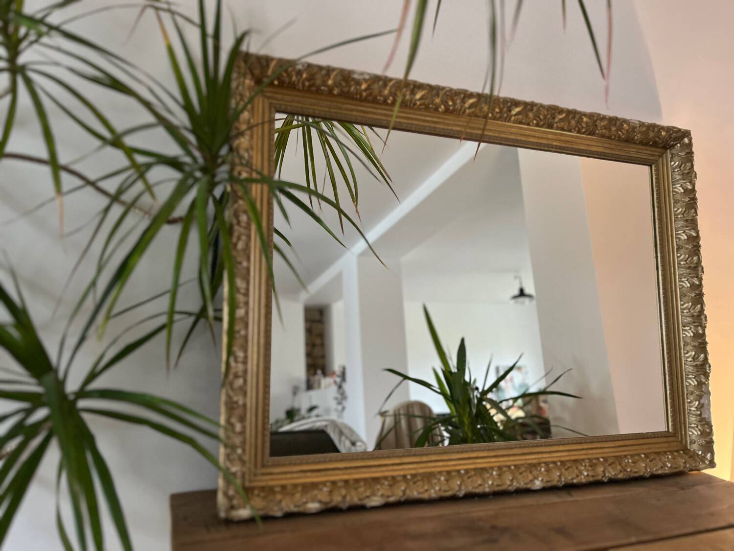 Antique mirror with a wooden and gilded stucco frame.
