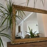 Antique mirror with a wooden and gilded stucco frame.