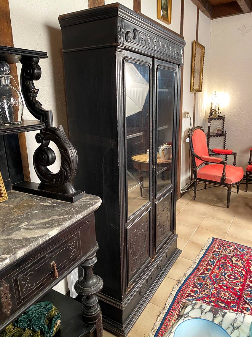 Blackened wooden display cabinet from the late 19th or early 20th century.