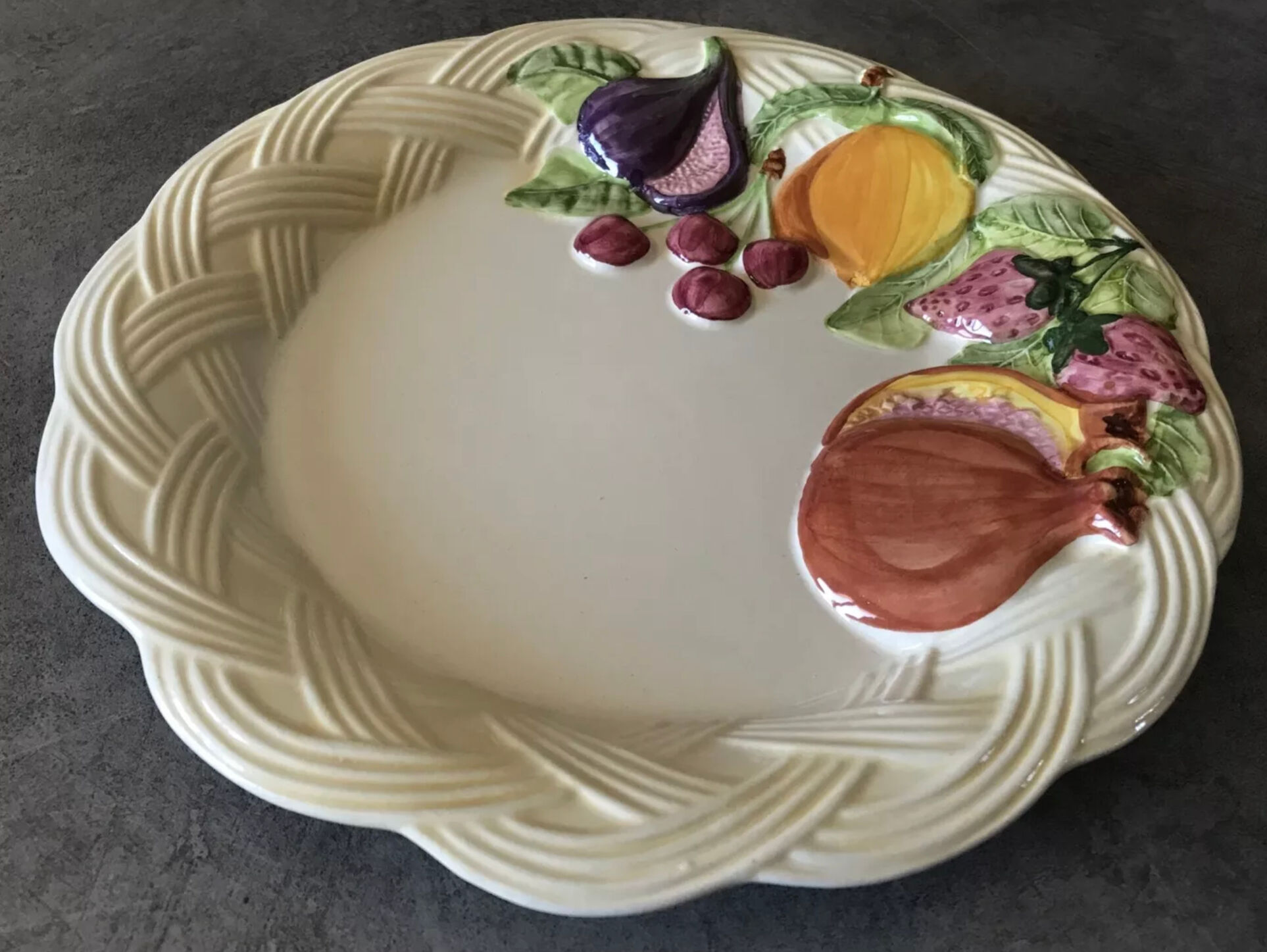 Vintage plate in ceramic enamelled decoration of fruits in relief