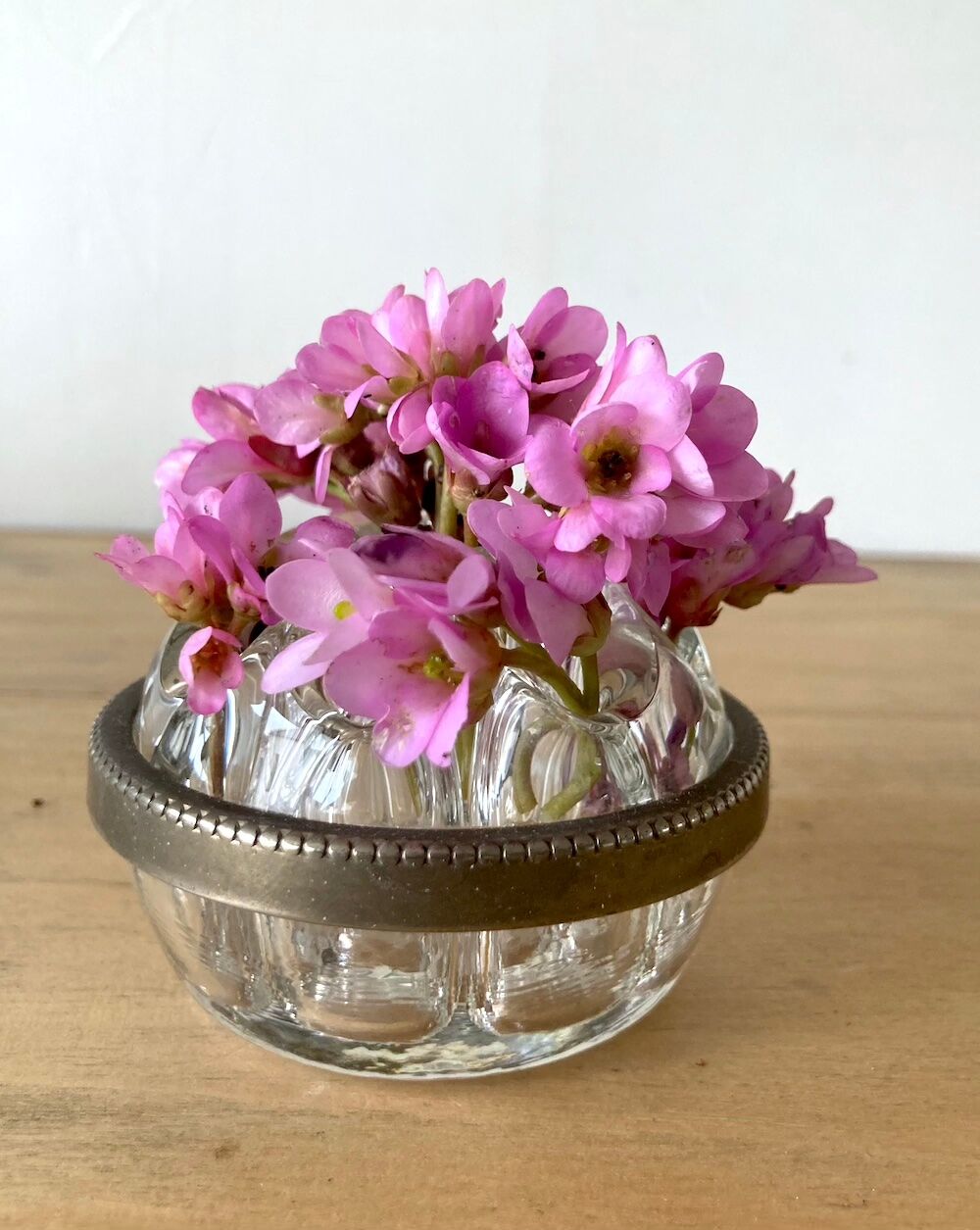 Pique flowers in metal circled glass