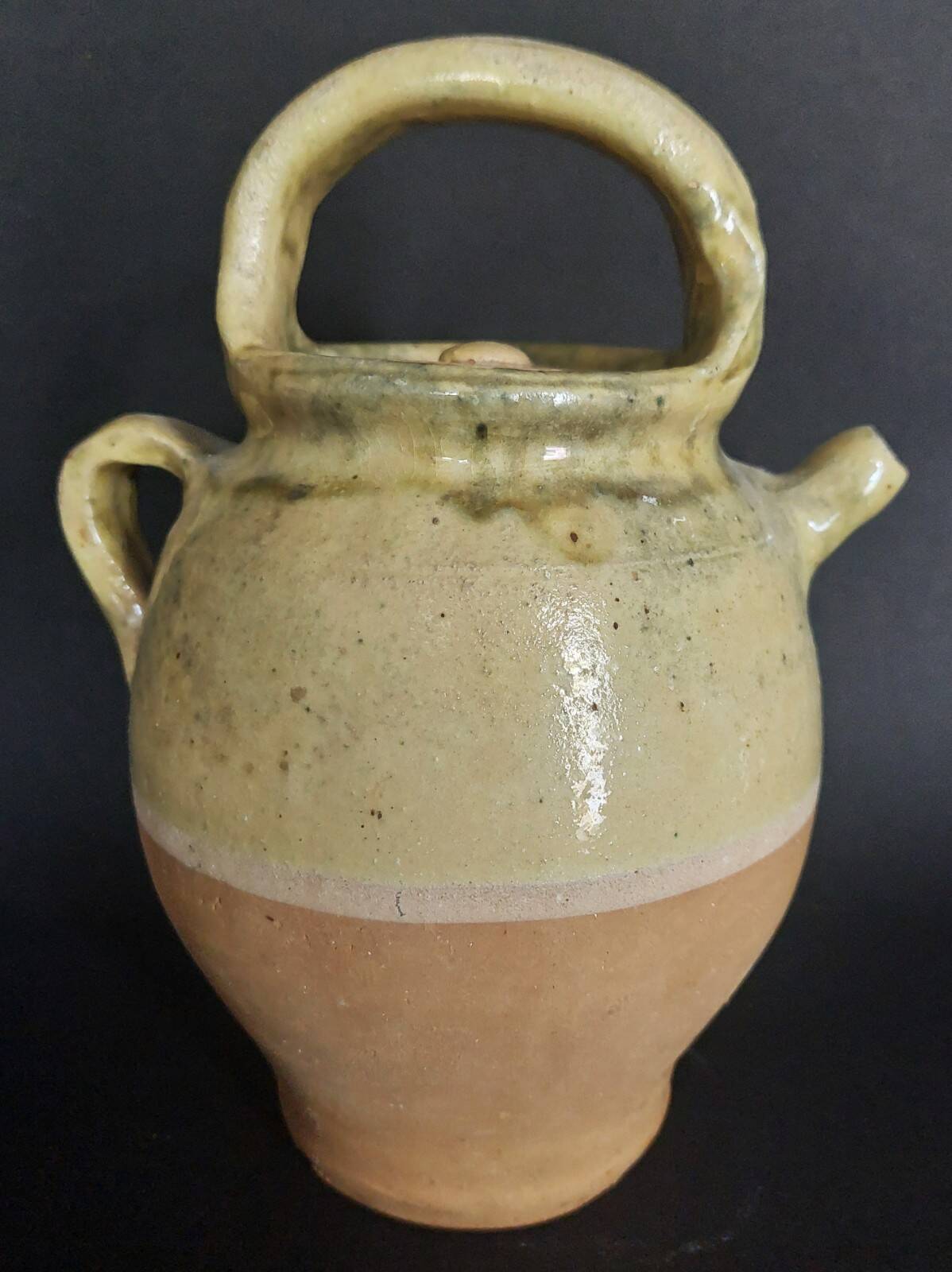 Yellow glazed terracotta gargoulette carafe with lid, early 20th century.
