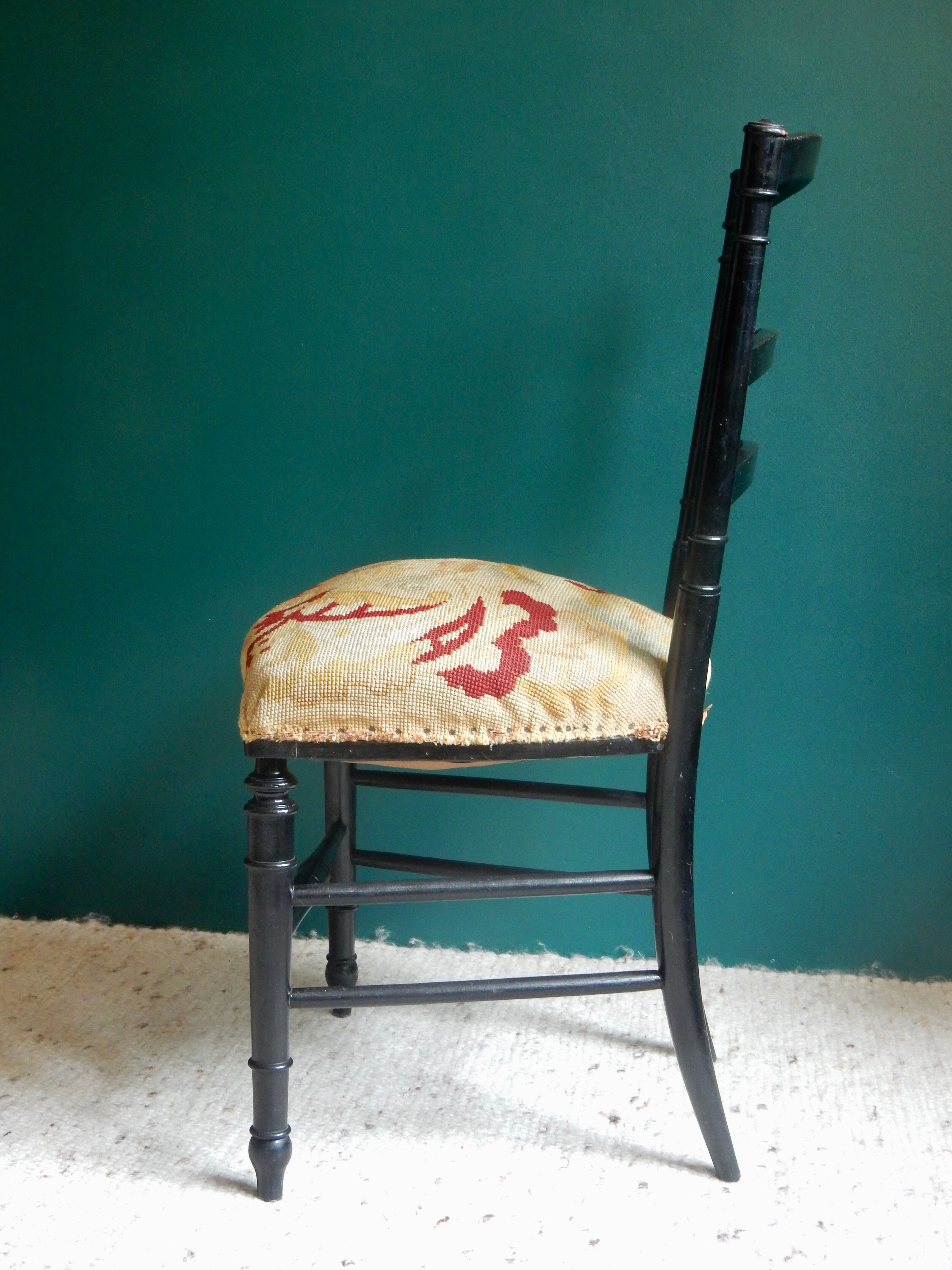 Black Napoleon III chair lined with phoenix