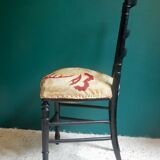Black Napoleon III chair lined with phoenix