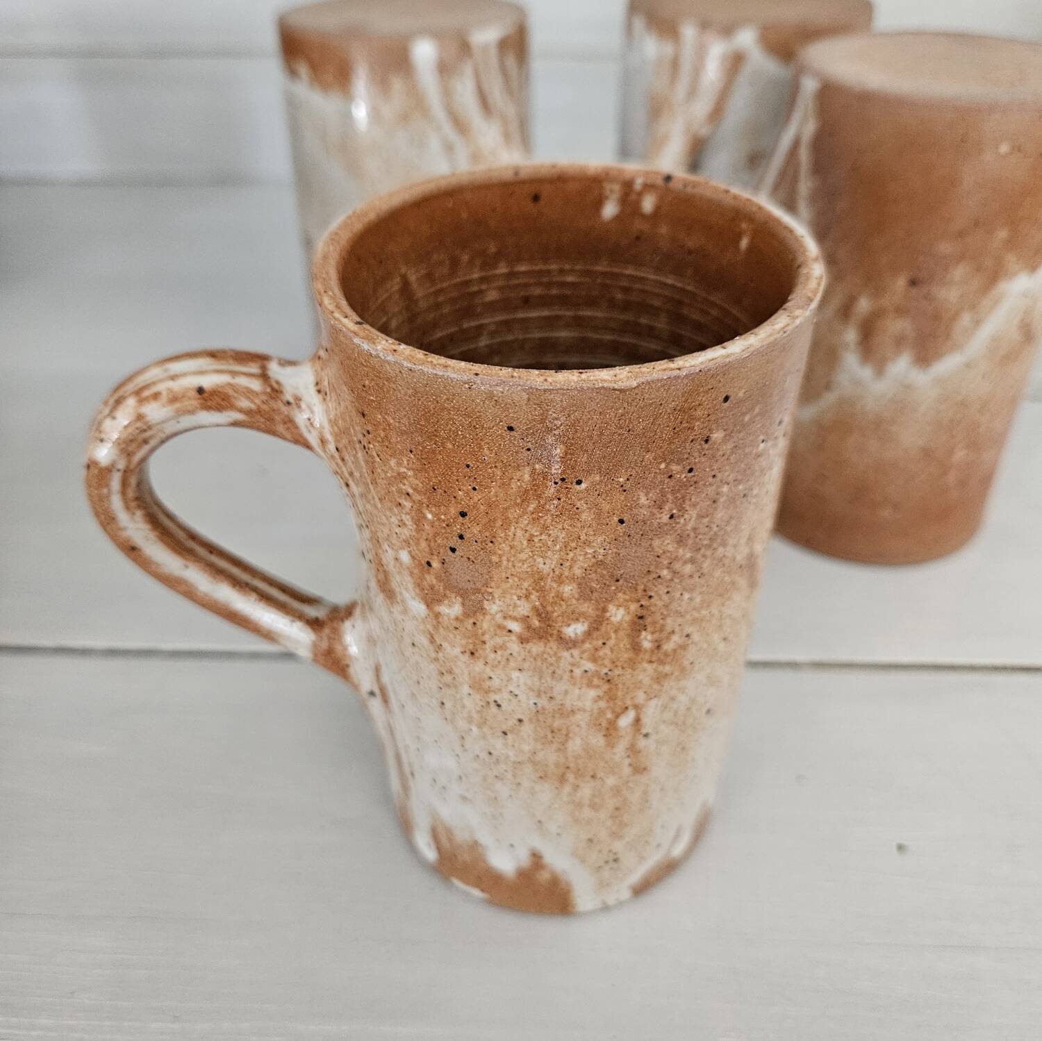 Set of 5 vintage handcrafted stoneware mugs in beige, pink, and white glazed stoneware