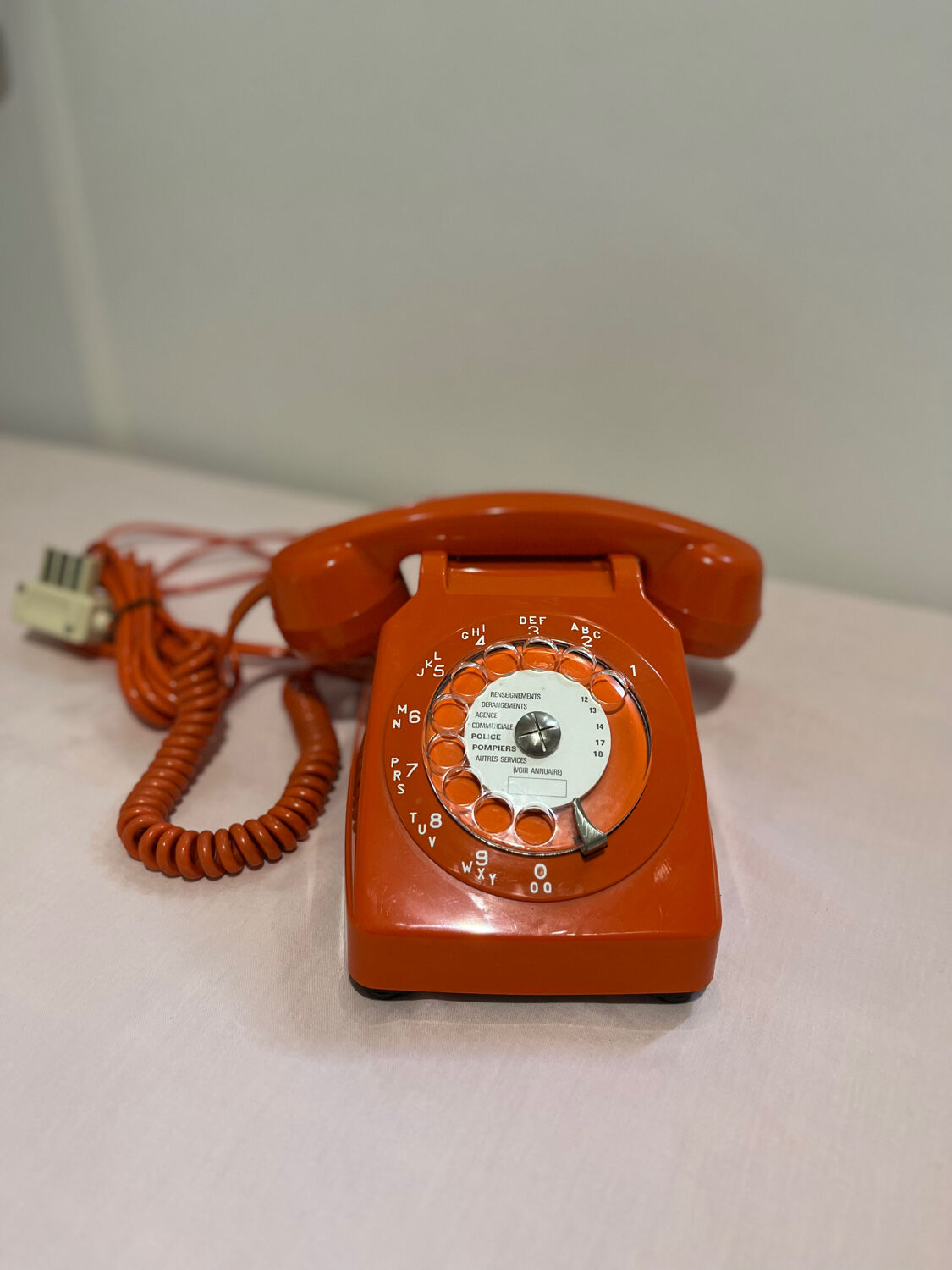 Orange vintage phone with socotel dial