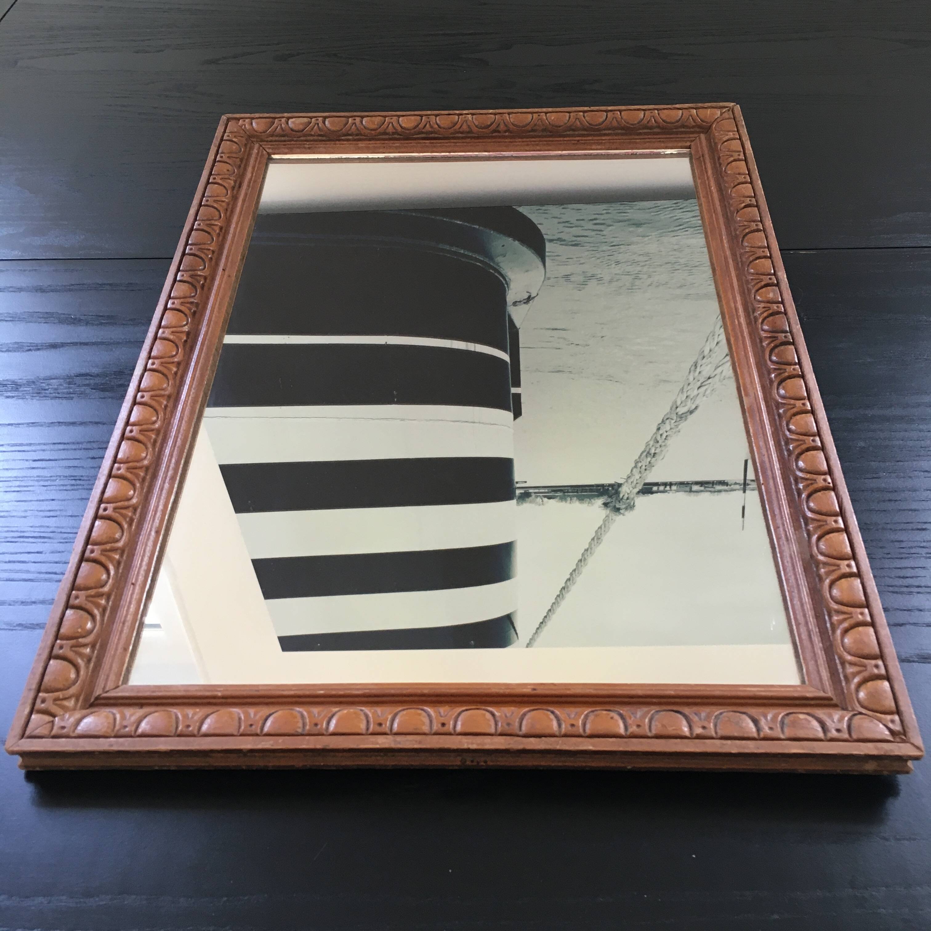 Antique mirror in ornate wood