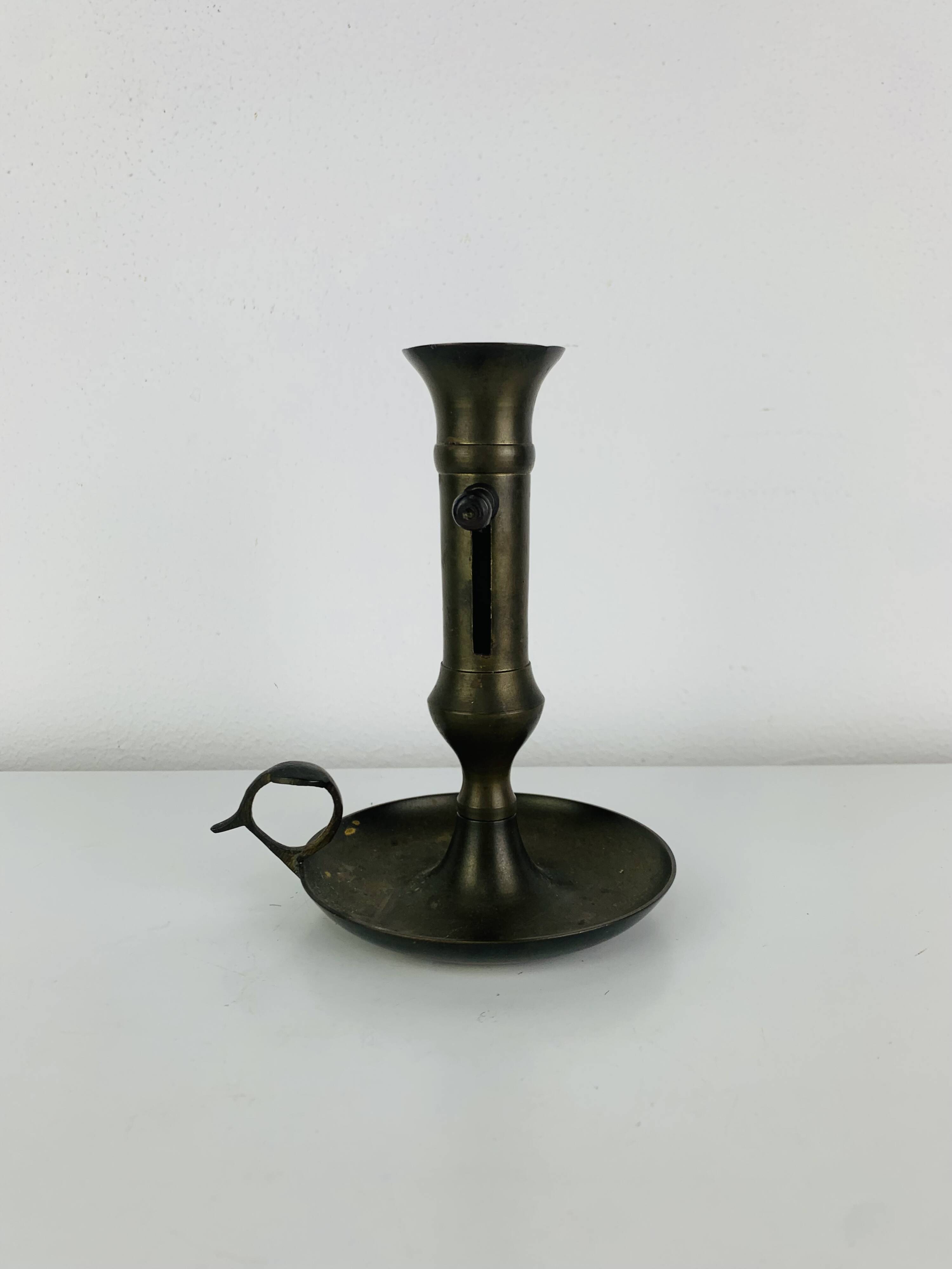 Vintage brass candlestick that raises and lowers.