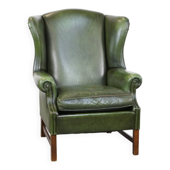 Green cowhide English Chesterfield wing chair with a comfortable seat