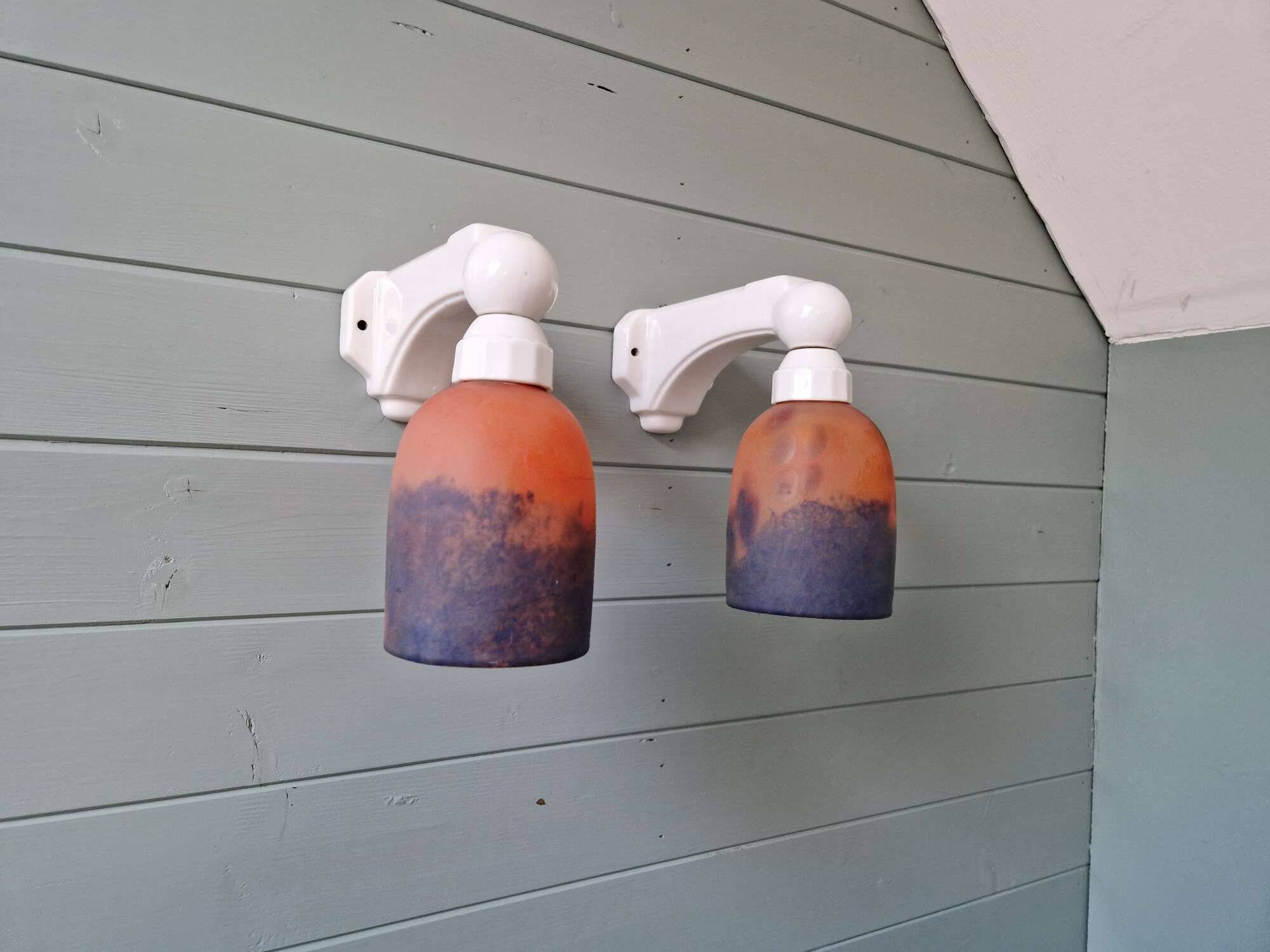 Pair of Art Deco wall sconces in multicoloured porcelain and frosted glass.