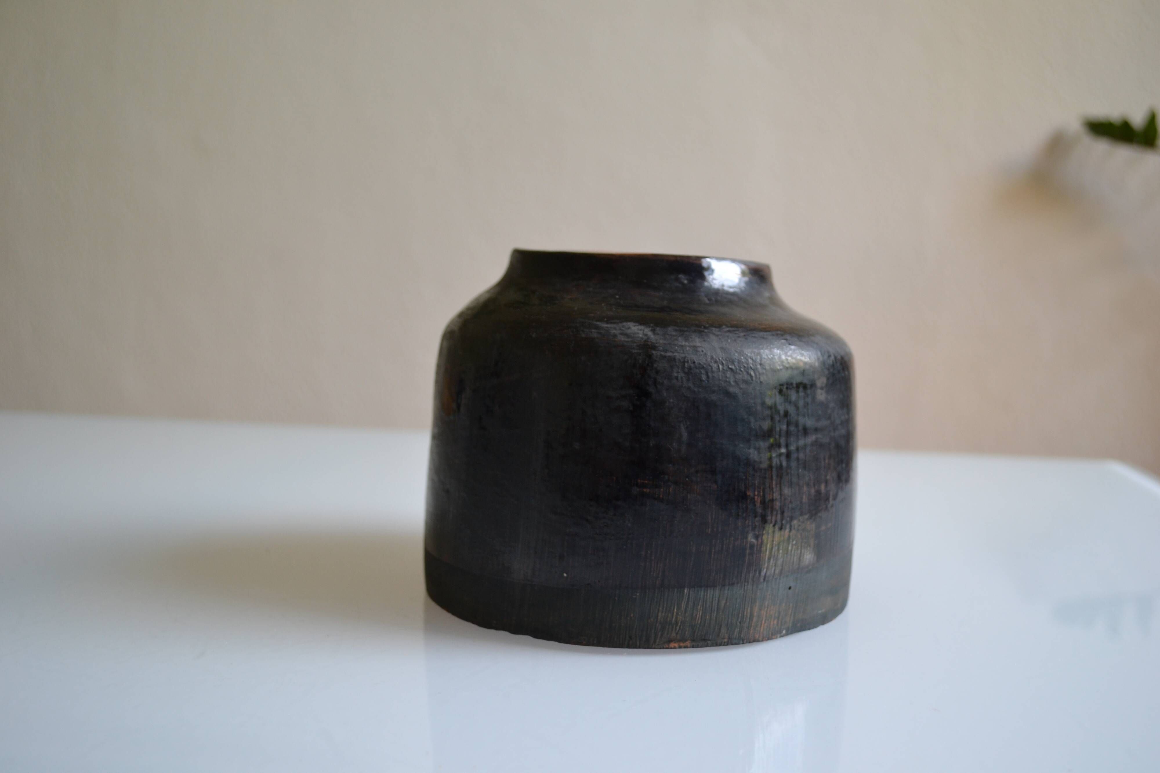 Ceramic vase with a signature fish to identify.