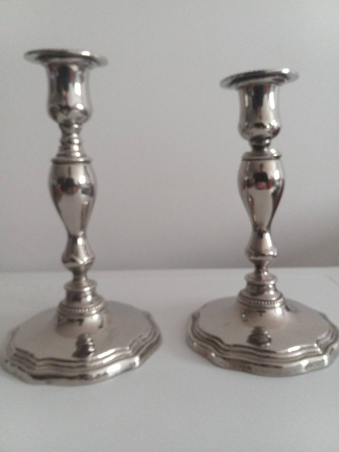 Pair of silver-plated metal candlesticks