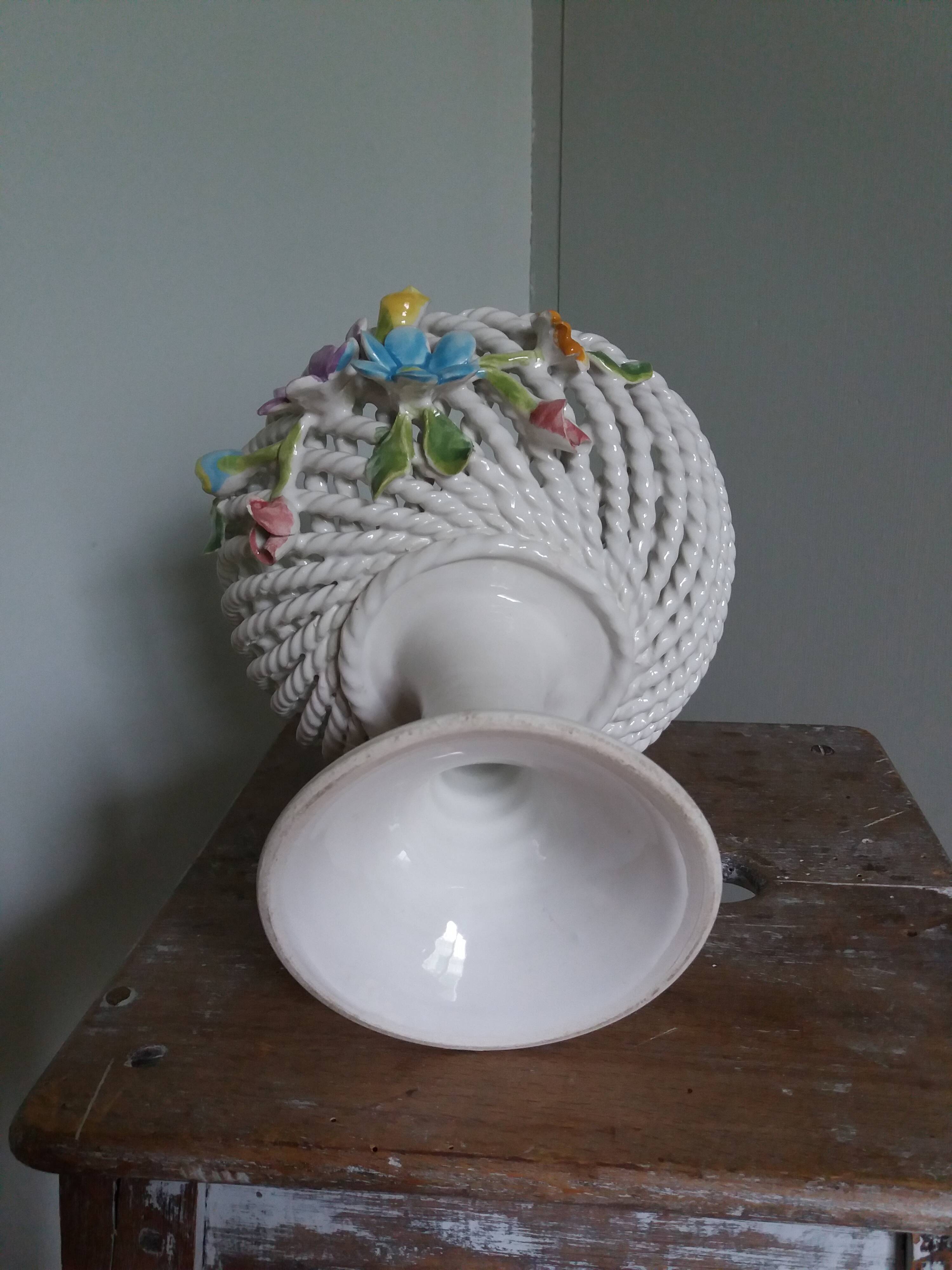 Cup on woven ceramic base with slip flowers