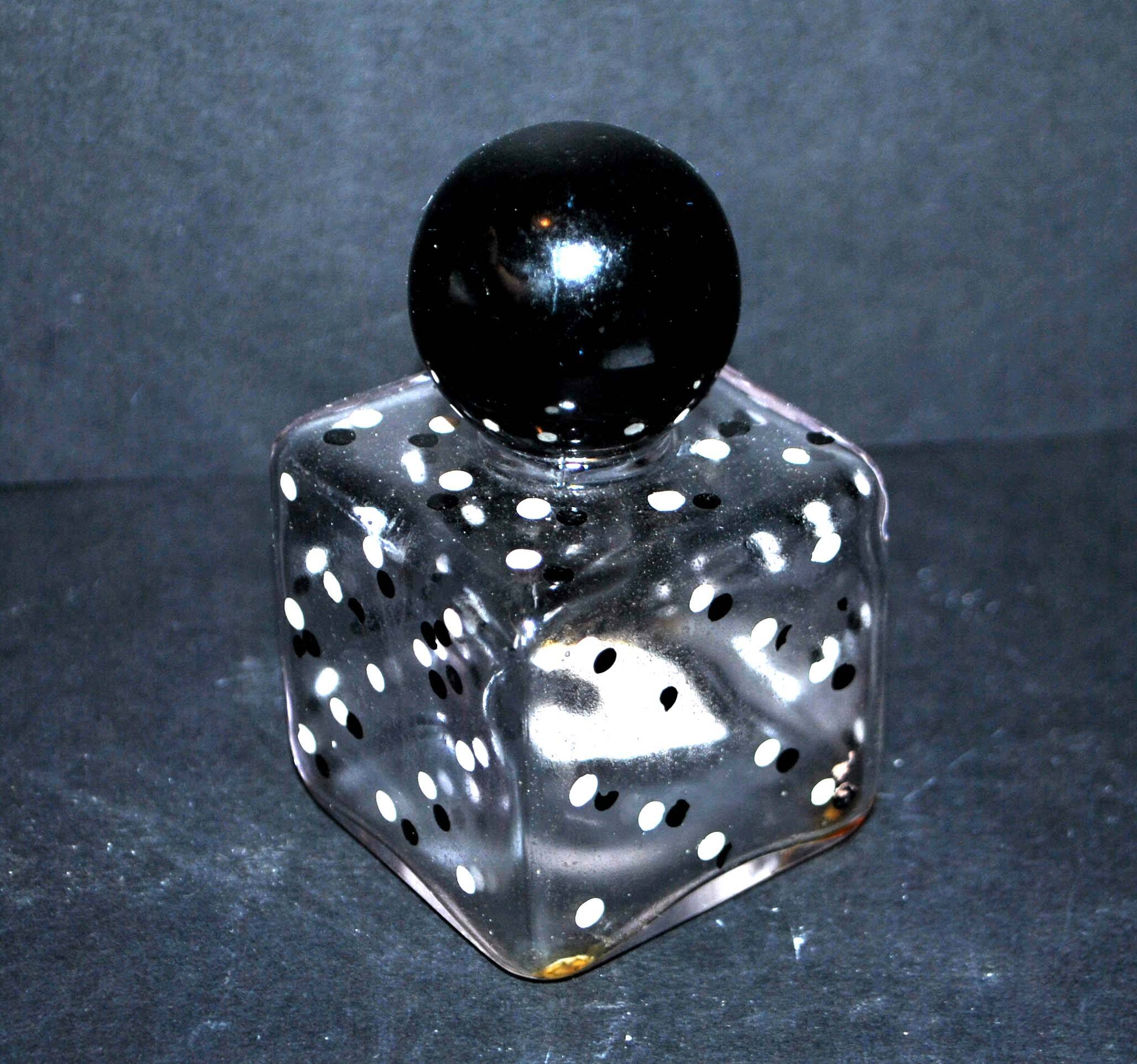 Vintage white and black polka dot glass perfume bottle and round bakelite cap