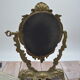 Adjustable psyche mirror of 33 centimeters in gilded bronze with angel ornament