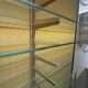 Vintage wooden and glass display cabinet, 15 shelves, gold background.
