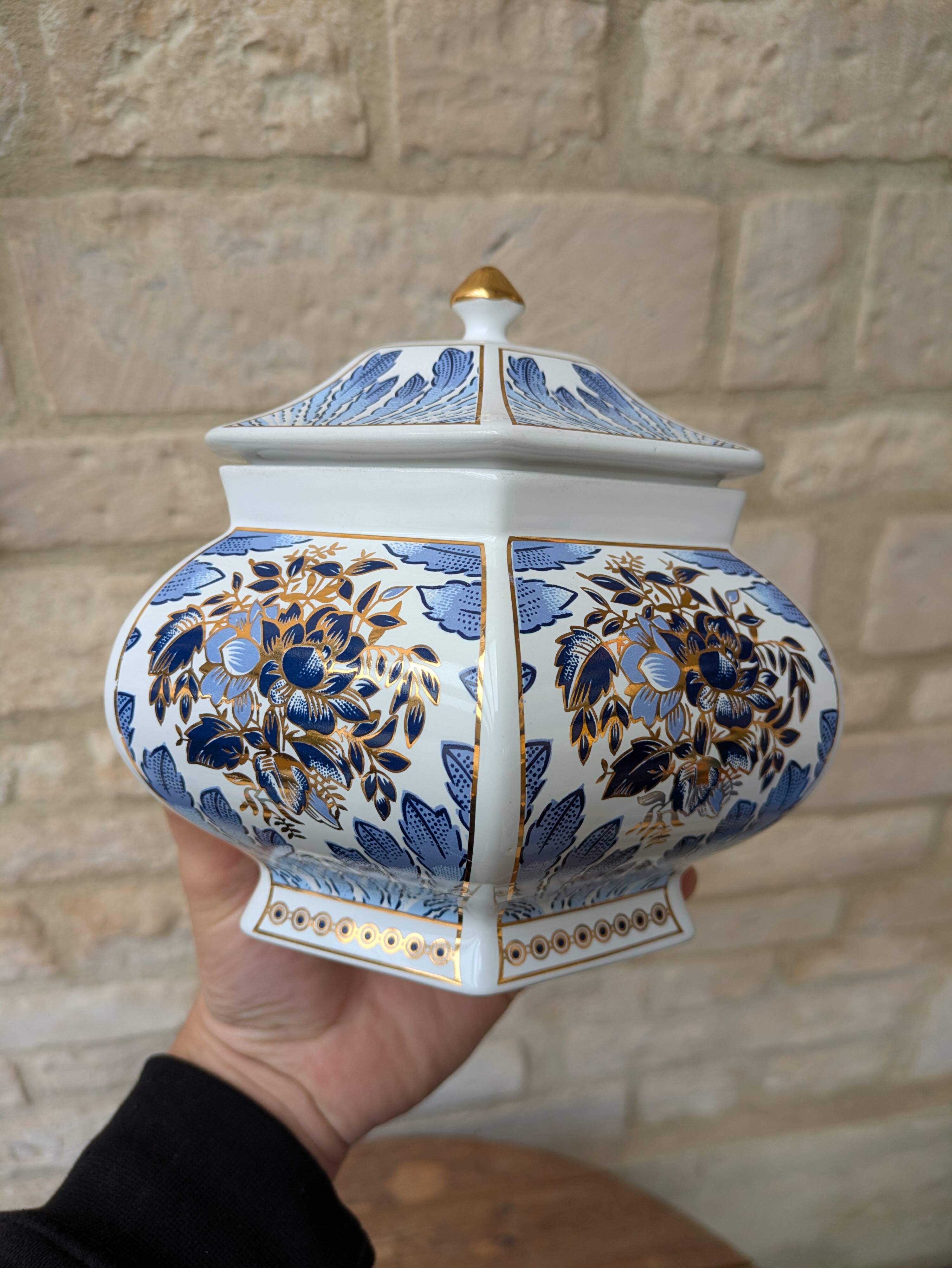 Decorative pot jar with a lid featuring a blue floral pattern and gilding.