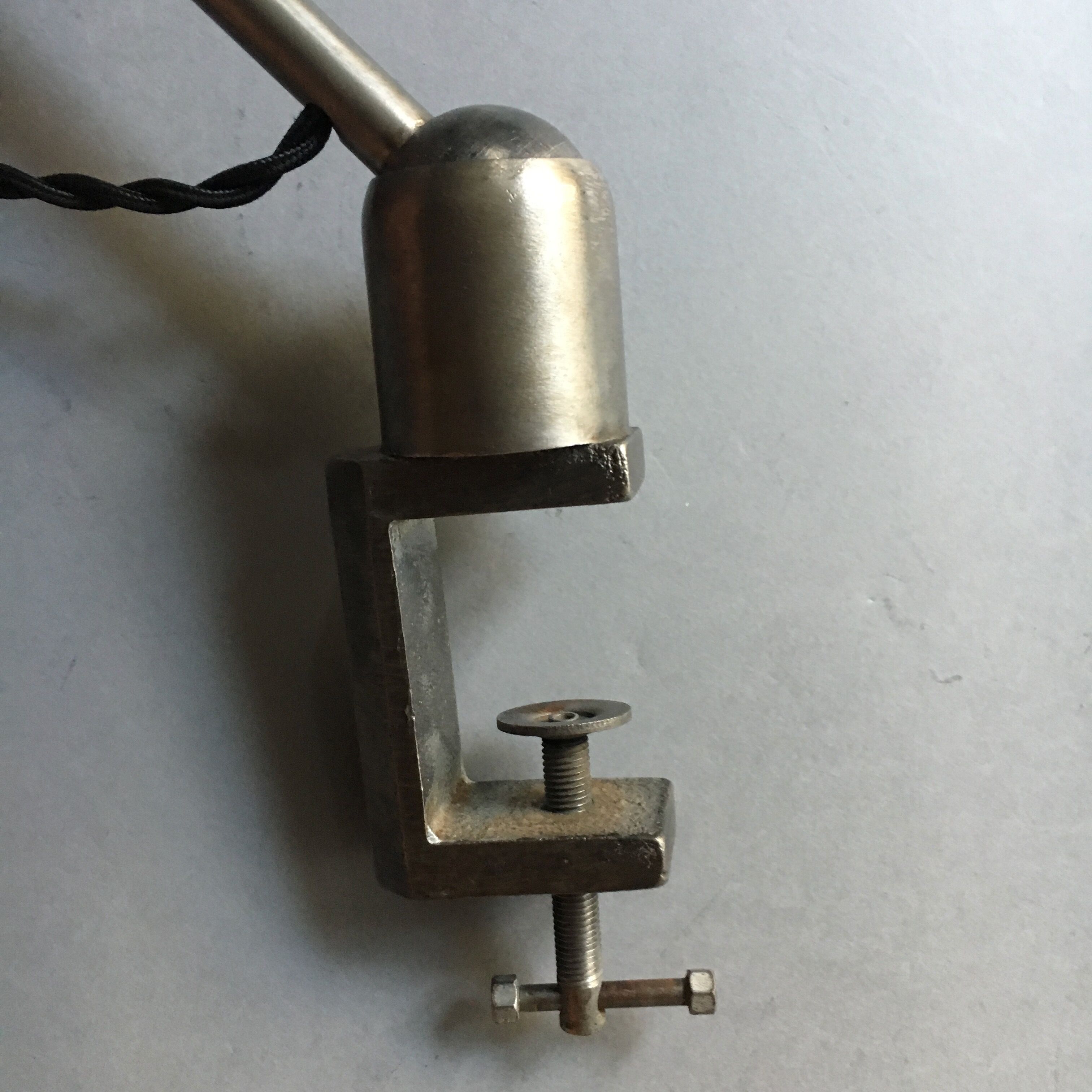 Old industrial lamp has vise 'mazda '.