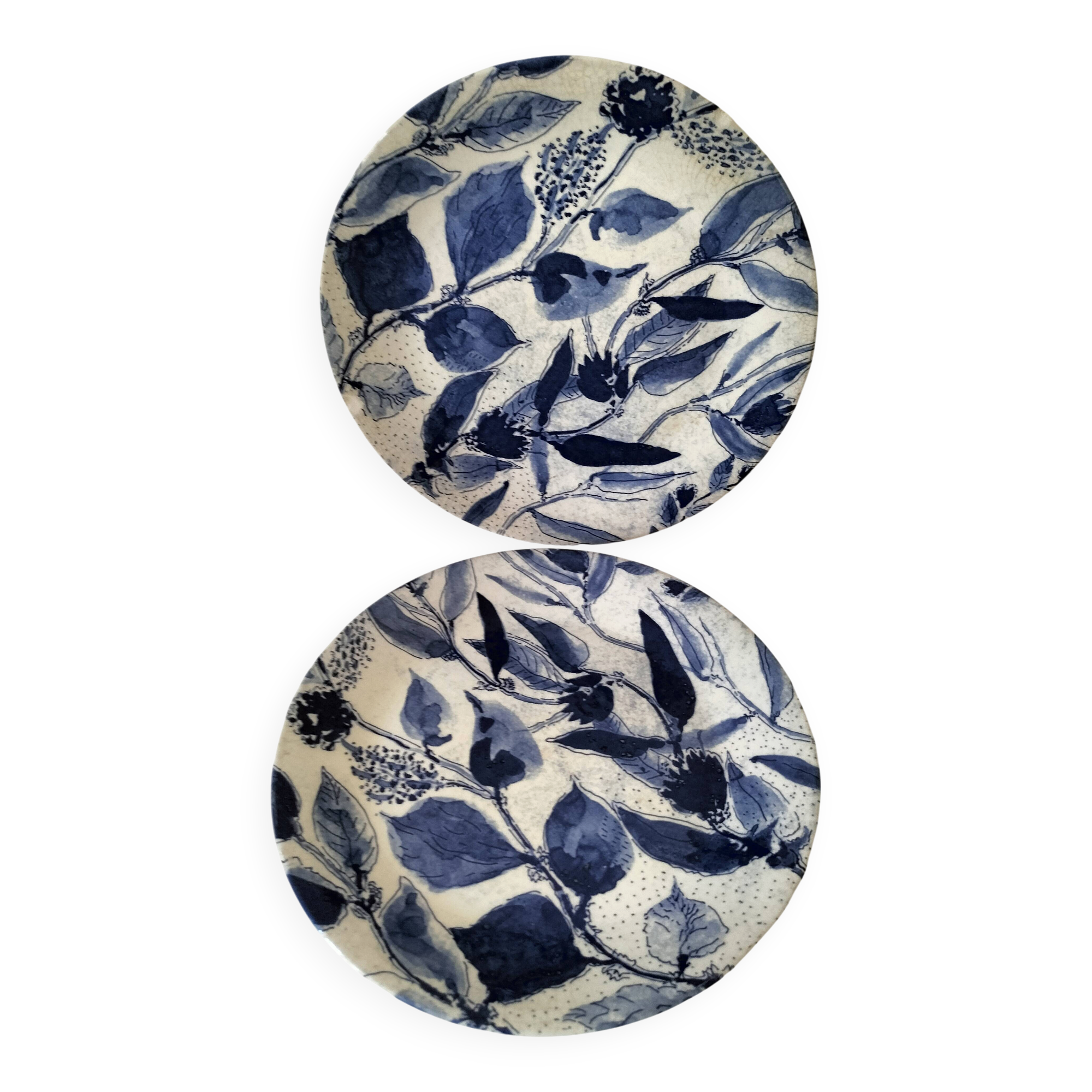 Two flat plates in earthenware with blue floral decoration.