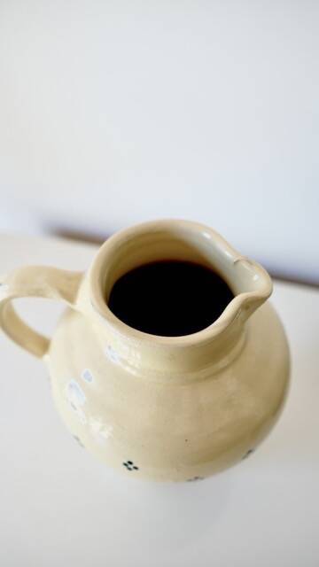 Vintage butter yellow ceramic pitcher in rustic style