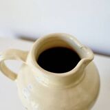 Vintage butter yellow ceramic pitcher in rustic style