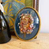 Oval frame bouquet of dried flowers with curved glass