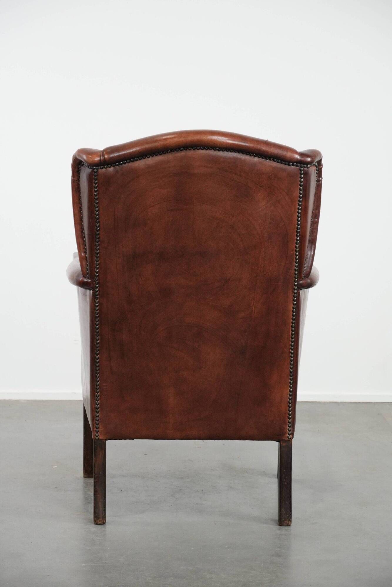 Classic vintage wingback chair in sheepskin and wood