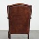 Classic vintage wingback chair in sheepskin and wood