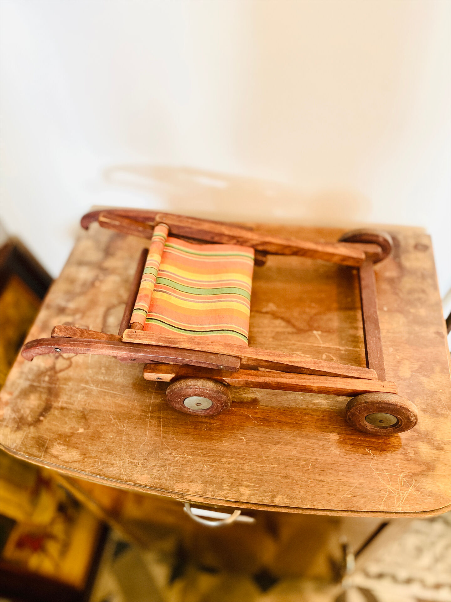 Vintage wooden folding doll's deckchair on wheels