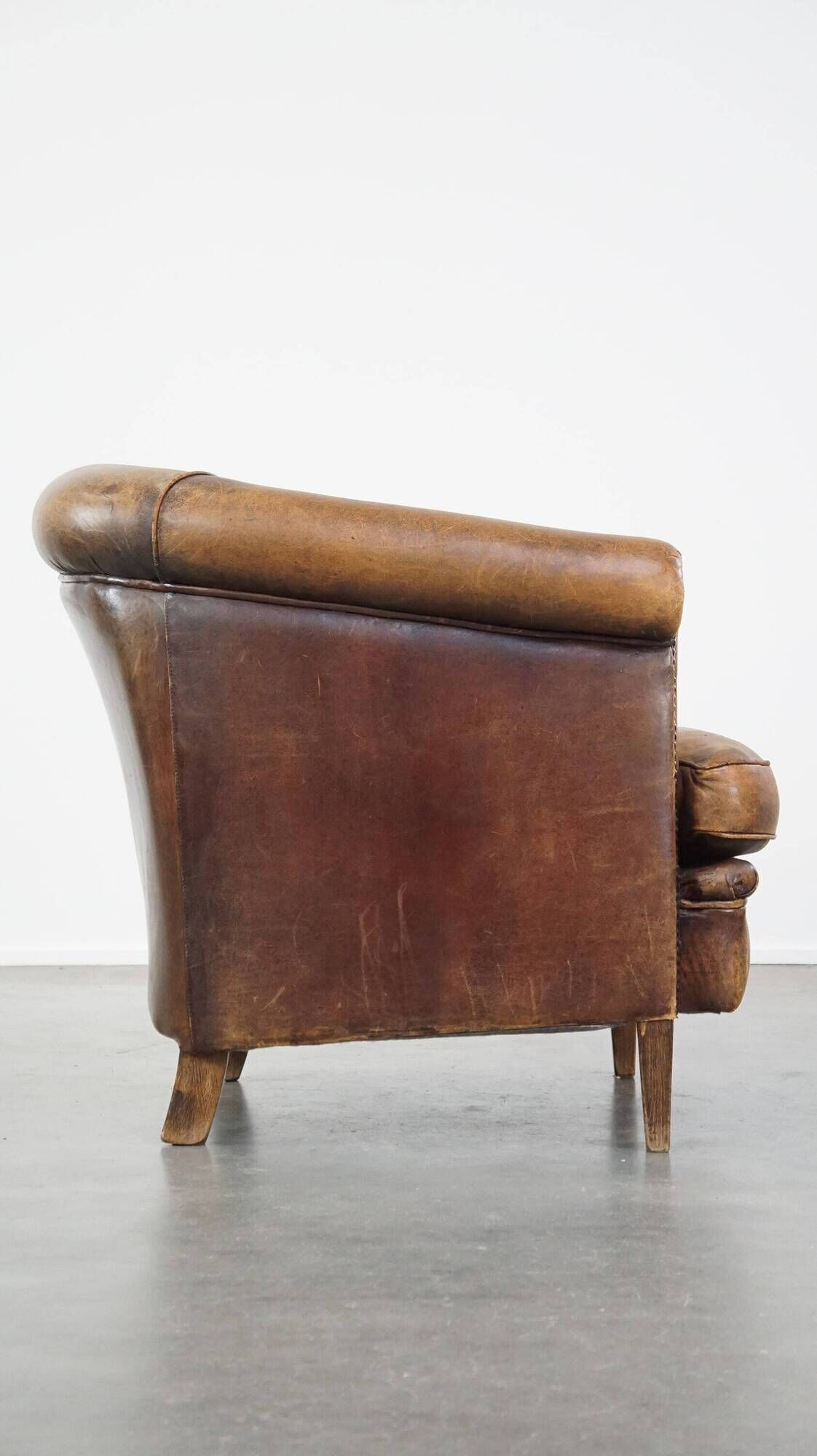 Characterful sheepskin leather club armchair with a luxurious, rustic appearance