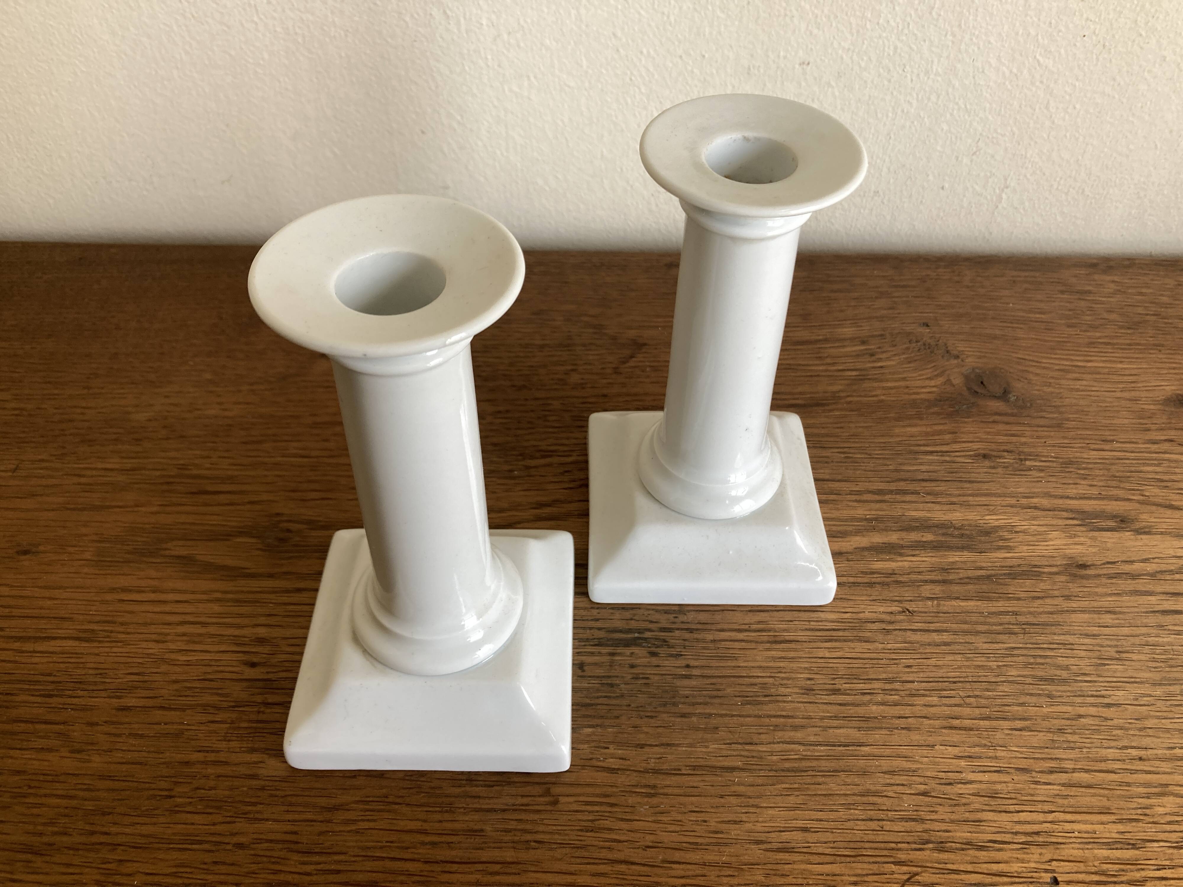 Pair of neo-classical Empire candlesticks from the late 19th century in white porcelain.