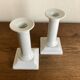 Pair of neo-classical Empire candlesticks from the late 19th century in white porcelain.