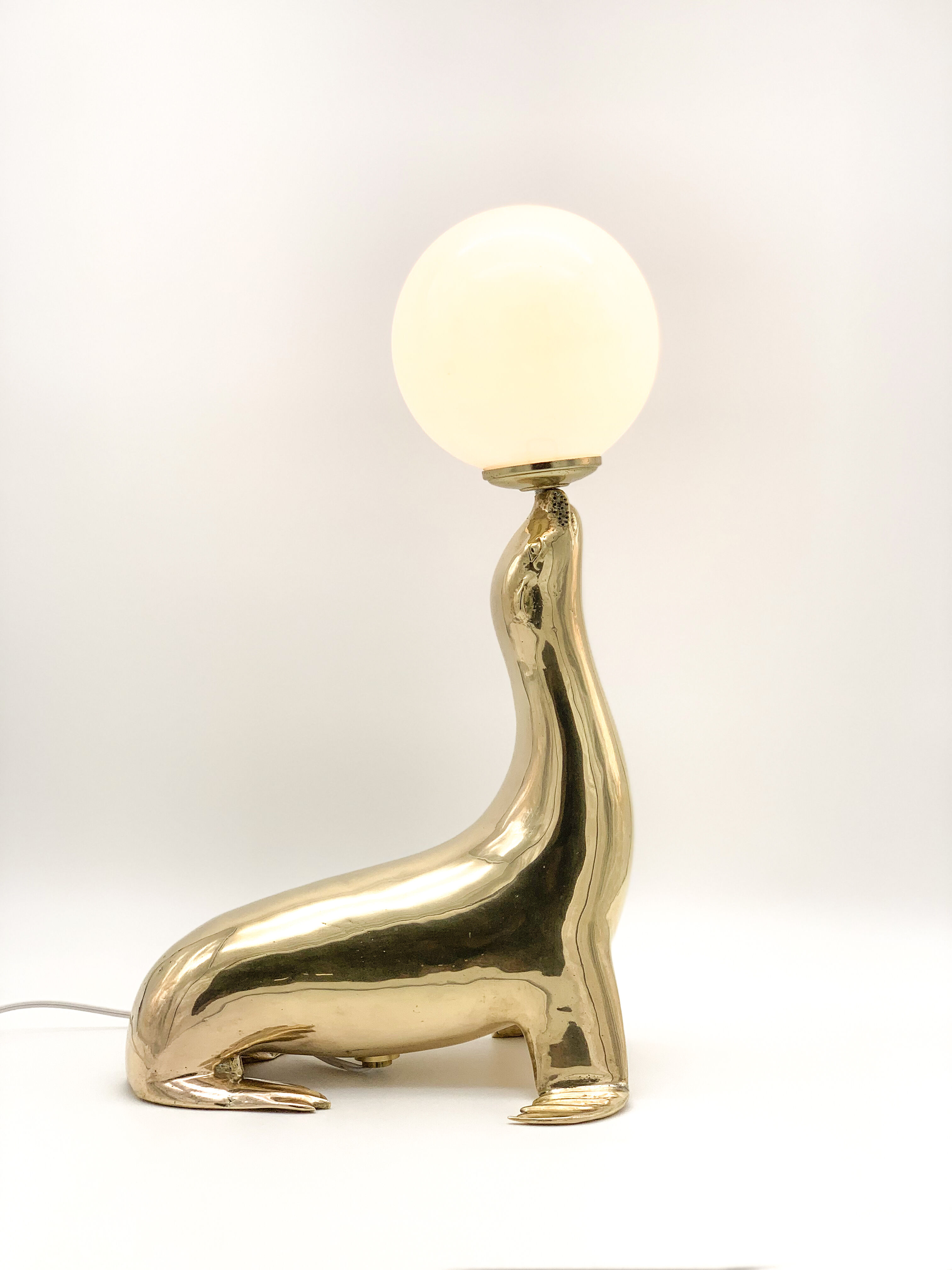 Vintage brass sea lion lamp