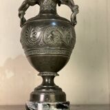 Bronze vase with snakes and a green patina, in the antique style.