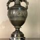 Bronze vase with snakes and a green patina, in the antique style.
