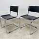 Paire de chaises cantilever simili cuir noir et chrome
