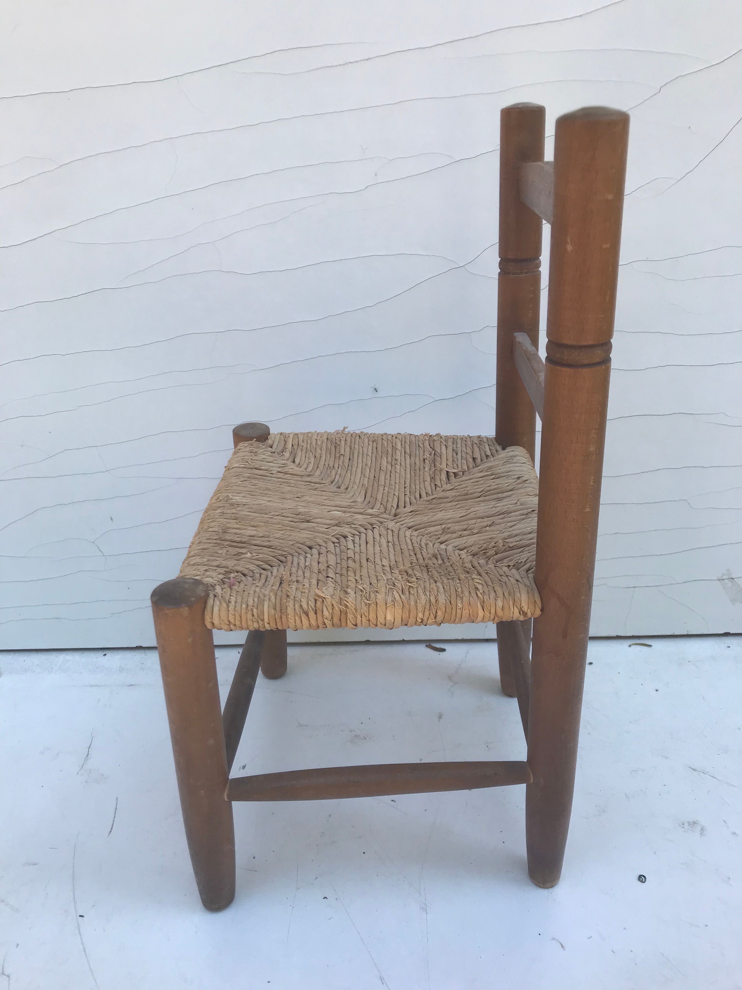 Old wooden children's chair with vintage braided seat