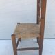 Old wooden children's chair with vintage braided seat