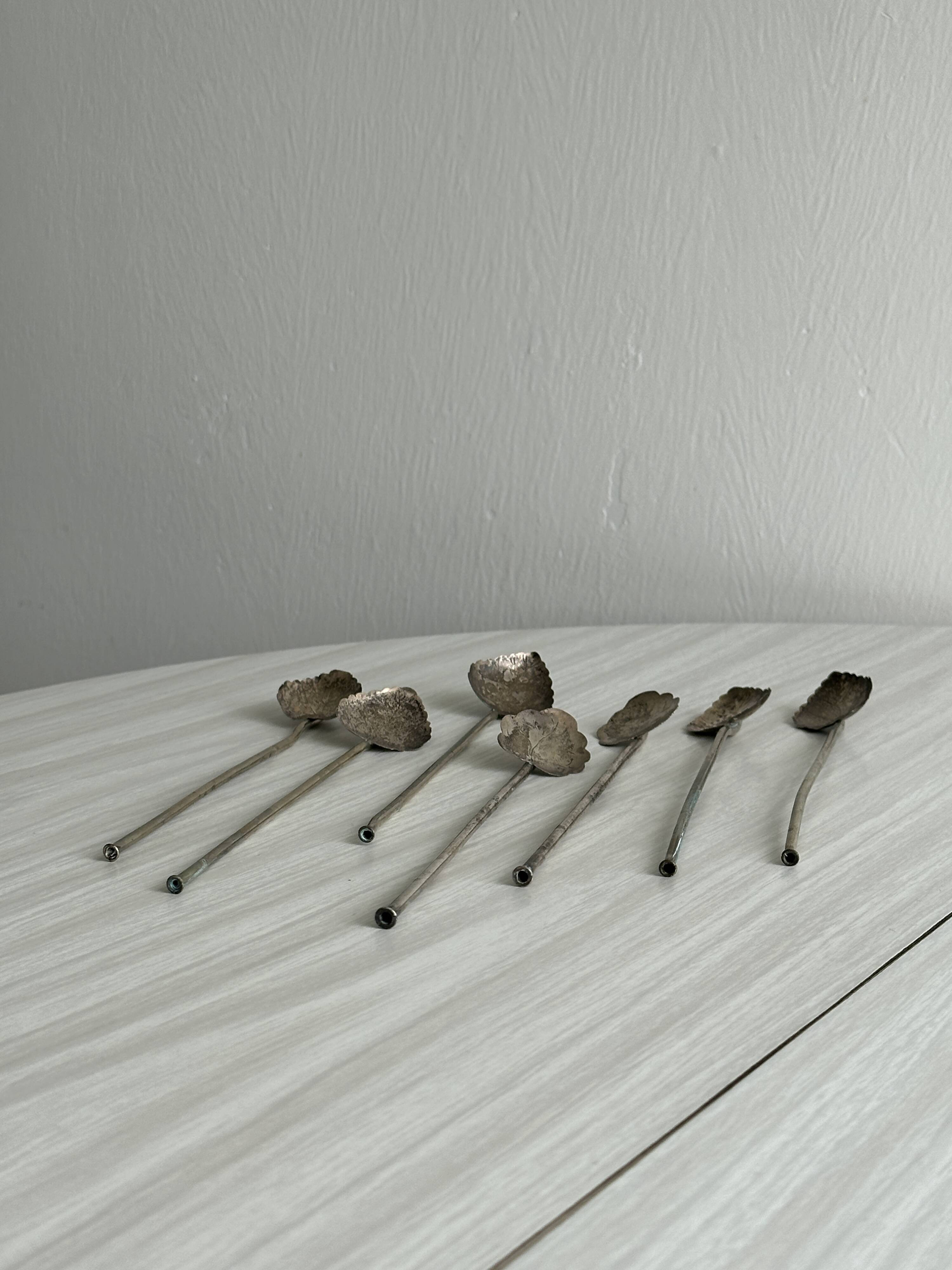 Vintage spoon in old metal, leaf pattern
