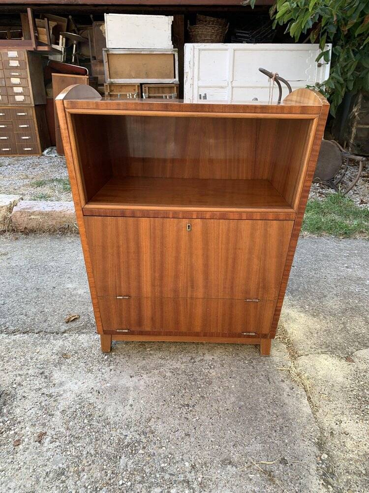 Brown trapezoidal wooden bar cabinet from the 1960s with a niche and lockable flap.