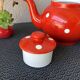 Vintage red teapot with white polka dots