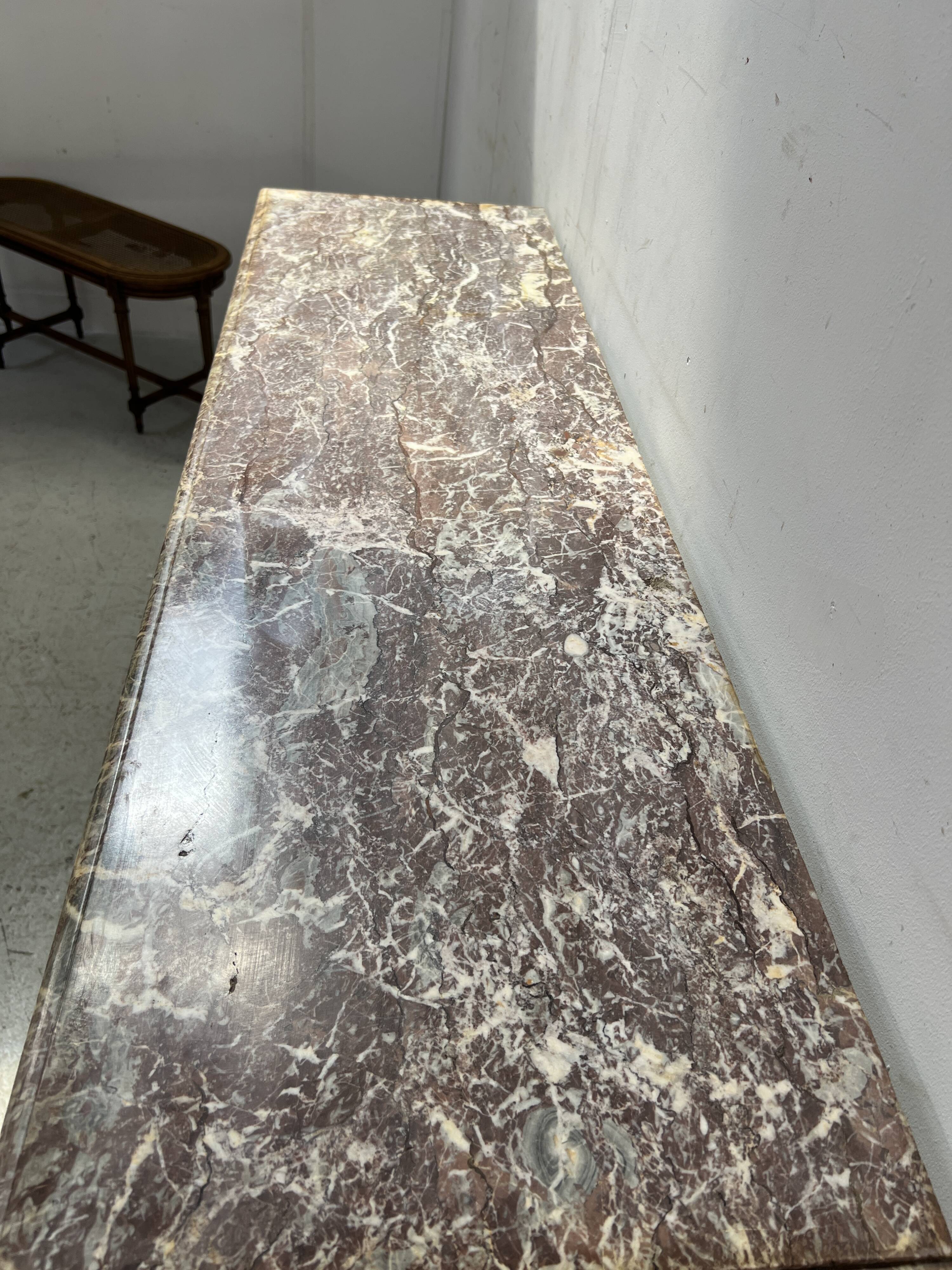 Louis XIV style fireplace in speckled red marble, 19th century.