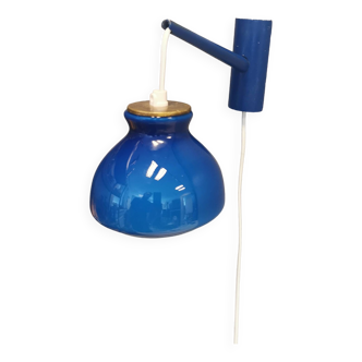 Holmegaard wall lamp with glass shade, and a brass detail on top. Wall bracket in wood painted blue