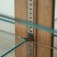 Antique Dutch oak display cabinet with glass shelves and a mirrored back