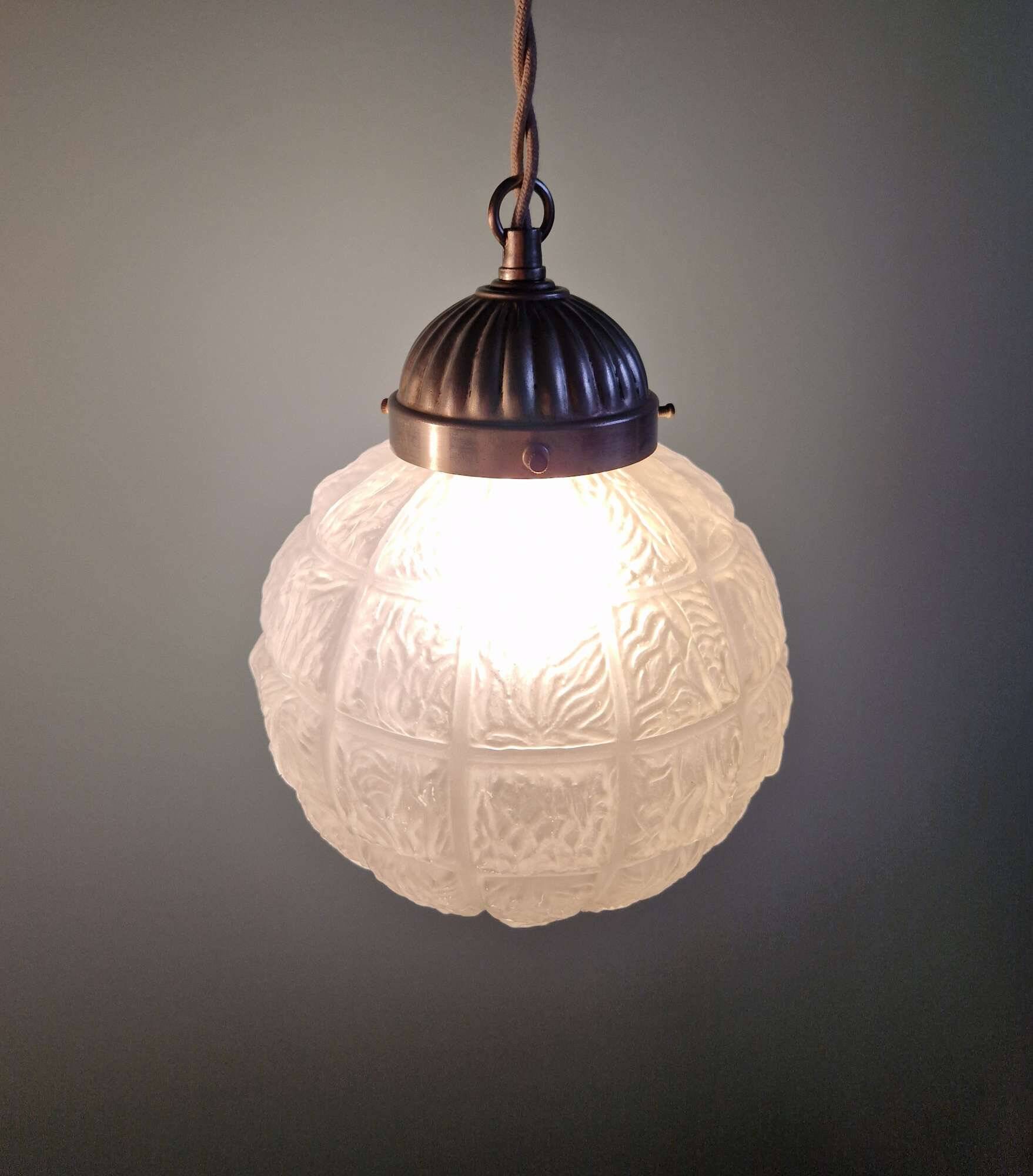 Art Deco trio of frosted glass pendants, 1920s-30s.