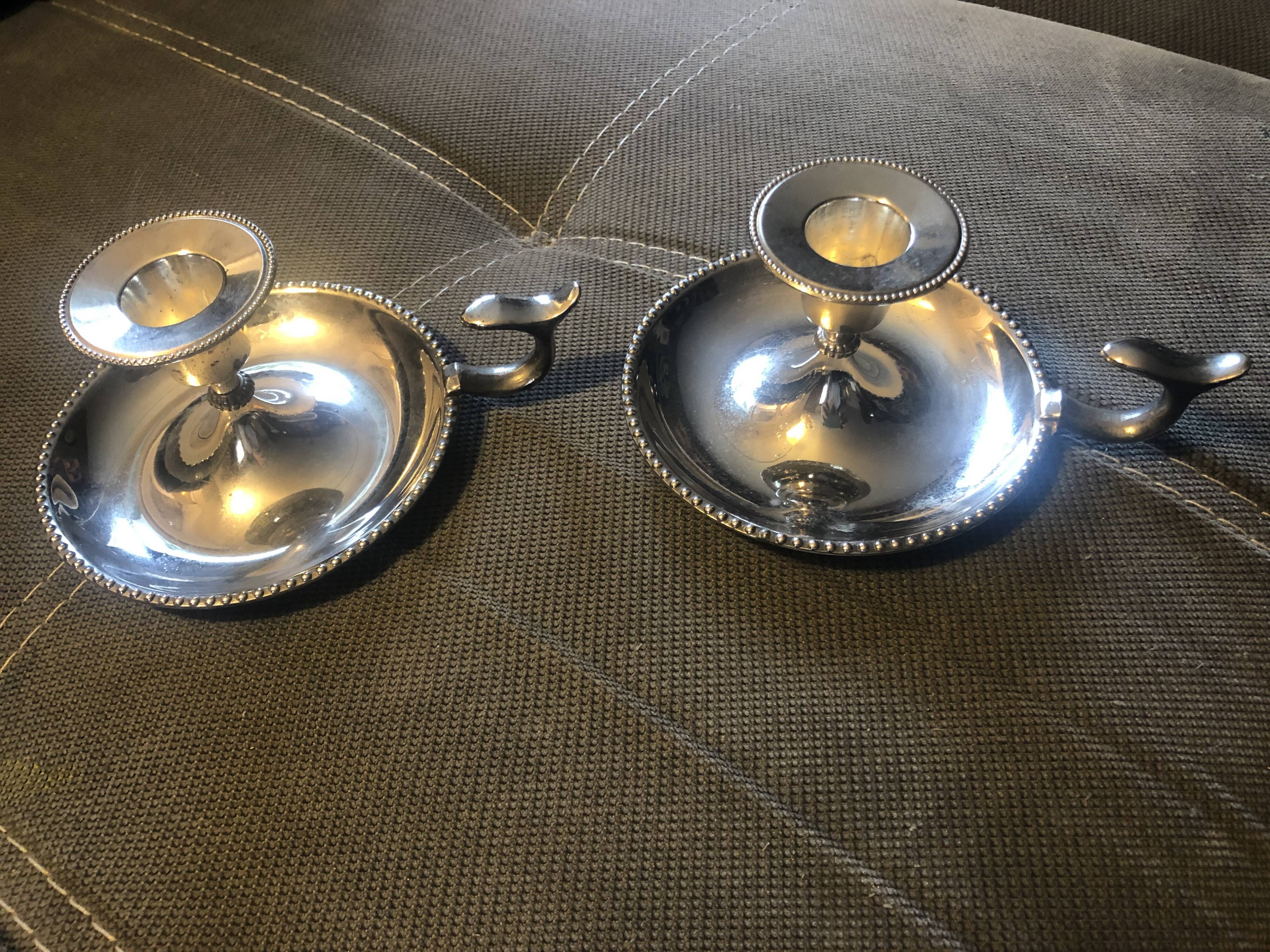 Pair of silver metal hand candle holders