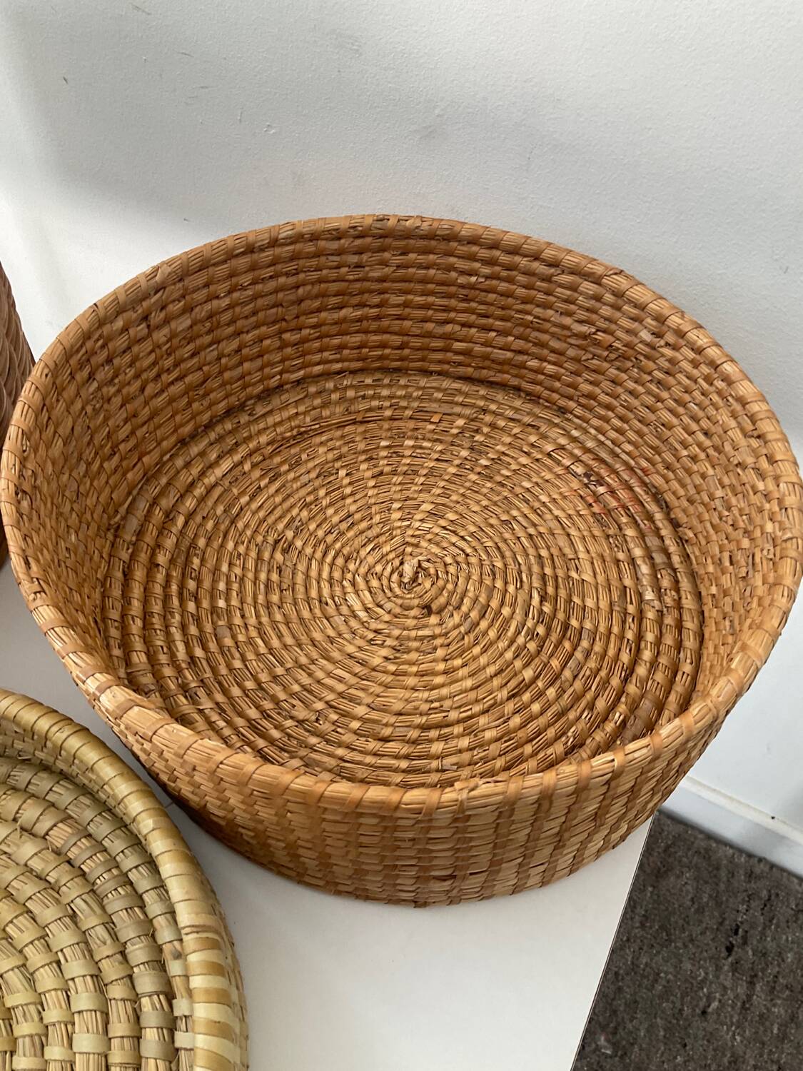 Trio of vintage wicker and woven raffia baskets
