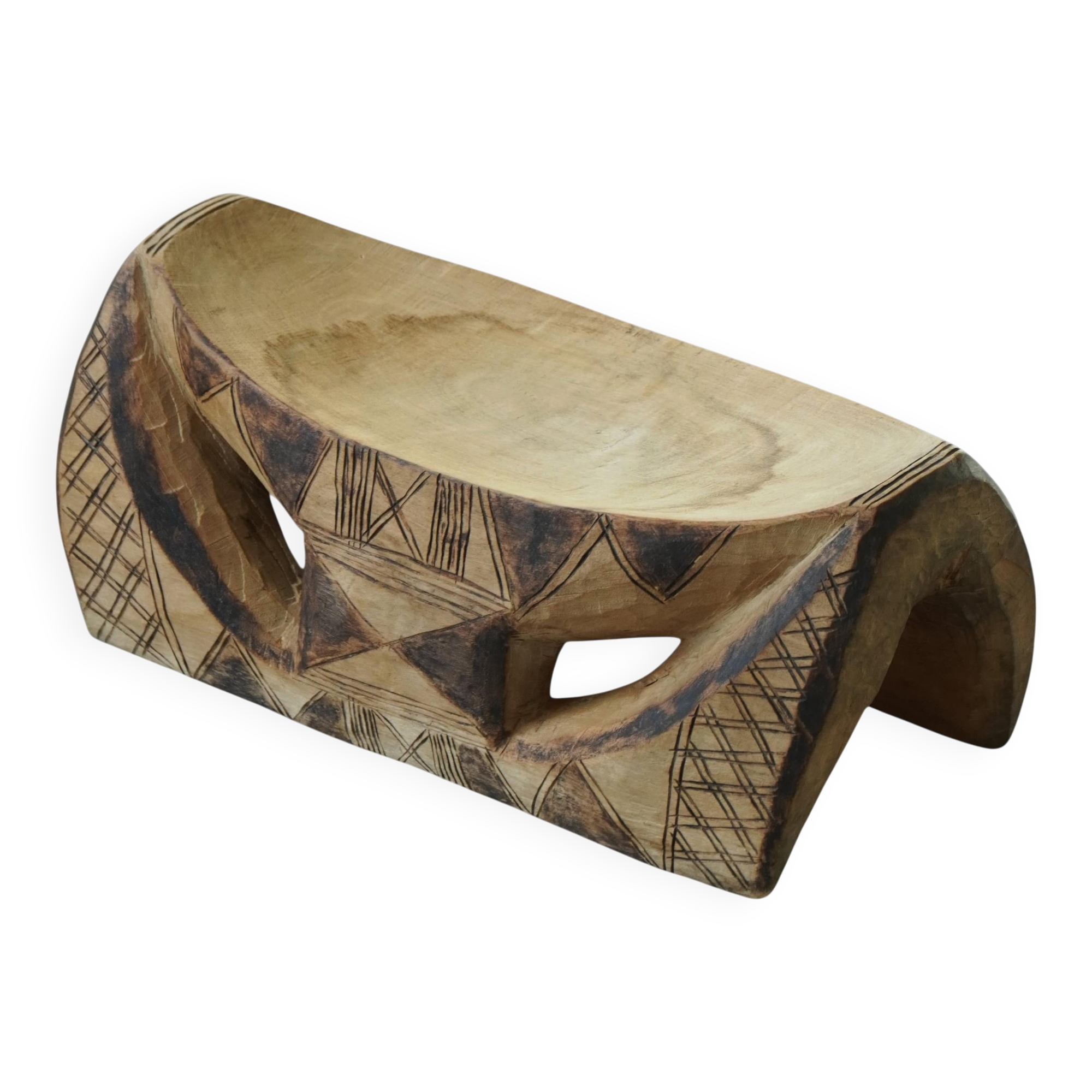 African sculptural stool in wood, hand-carved and adorned with geometric patterns, 1950s.