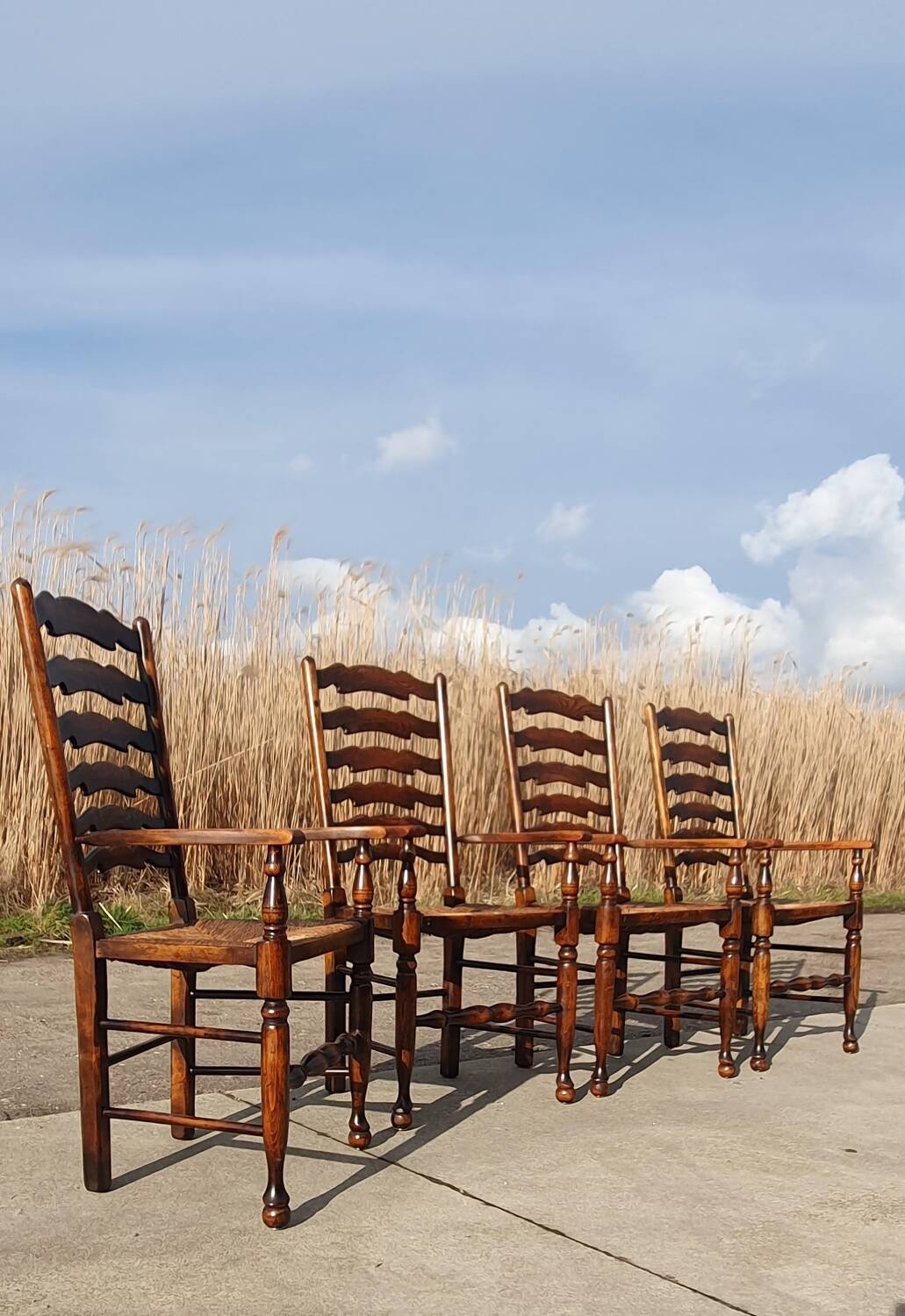 Set of 4 rustic vintage armchairs in English farmhouse style with rush seats.